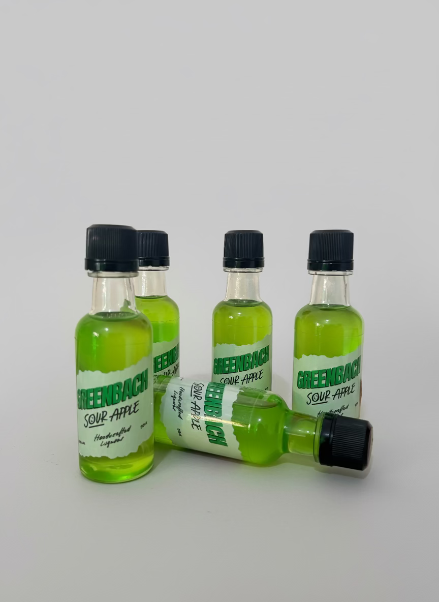 Four small bottles of Greenback Sour Apple on a white background